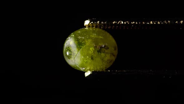 Natural Hydrogrossular Green Garnet in Tweezer on Turn Table