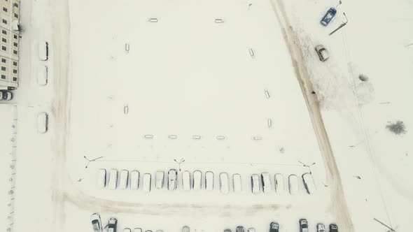 Cars on a City Road Covered with White Snow After a Blizzard