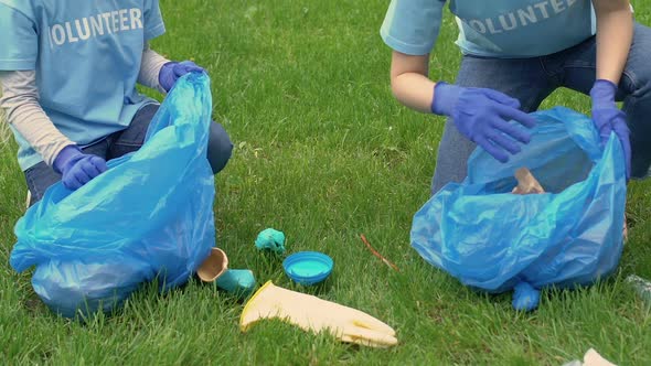 Two Volunteers Picking Litter on Lawn in Park, Ecology and Environment Concept