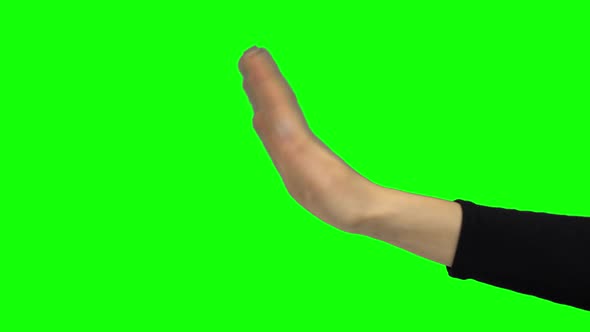 Arm in Black Blouse Gesturing Stop. Green Screen. Close Up