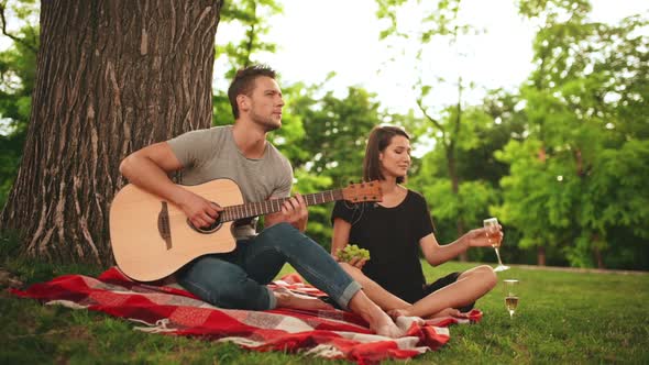 Young Beautiful Couple Smiling Resting in Park