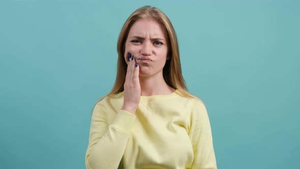 Girl Isolated on Turquoise Background Suffering From Severe Toothache.