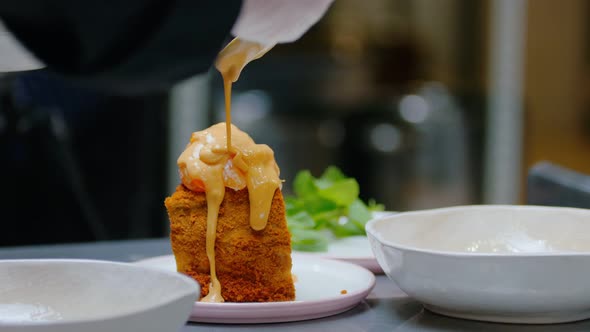 Pouring a Sweet Sauce on the Top of Honey Cake