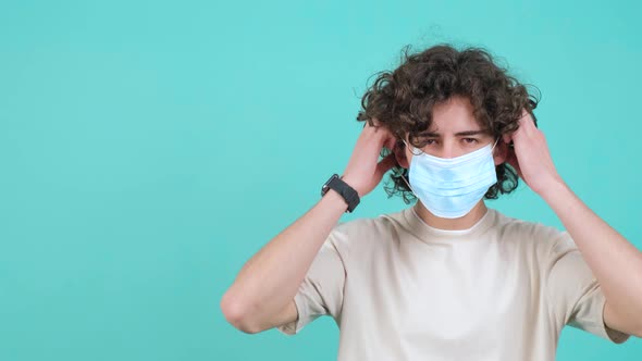 Man Puts a Mask on His Face From Coronavirus and Doing Thumb Up Gesture