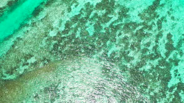 Aerial top down texture of perfect lagoon beach lifestyle by clear ocean and white sandy background 