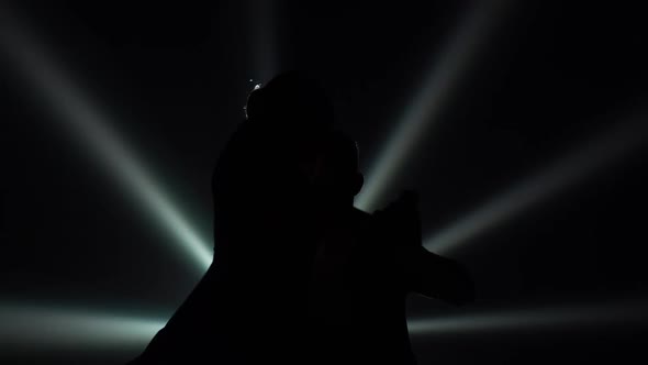 Bottom View of Black Silhouettes of Dancing Couple Performing Elements of Argentine Tango