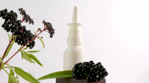 Nasal Spray With A Black Berry On A White Background, Homeopathic Treatment,Elderberry Medical Nasal