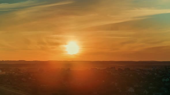 Timelapse From a Sunset Above the Hills. City Crossing Into the Night in 