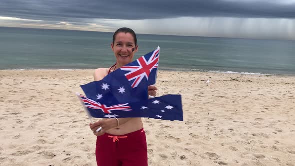 Smiling Woman Waving Two Australian Flags