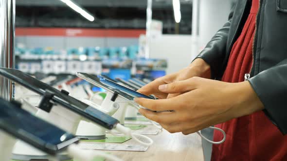 Young Woman Hands Take New Black Smartphone and Examine