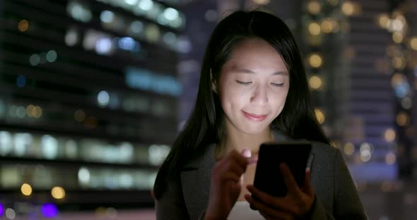 Woman Read on Smart Phone in City