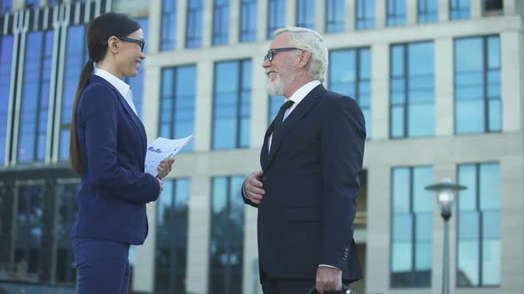 Elder Male in Business Suit Waiting Young Female Partner Near Office Center