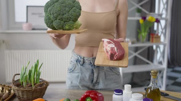 Front View Unrecognizable Woman Choosing Broccoli or Beef Steak for Dinner