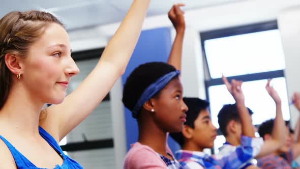 Student raising hand in classroom