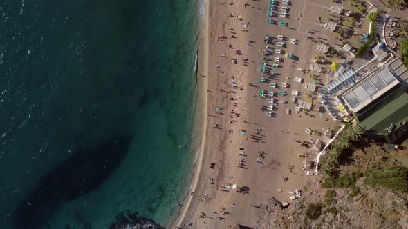 Top Aerial Drone Shot of Beach Seascape with People Silhouettes