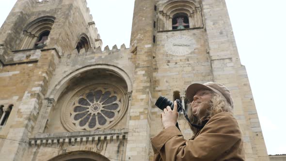 Girl in Cap Photos Famous Church with Camera on Windy Day