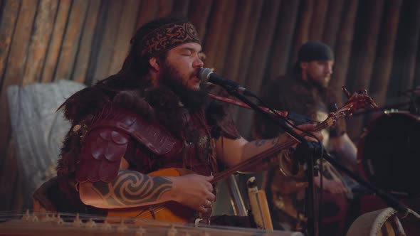 Man in Tribe Clothes Plays Tovshuur and Sings on Stage