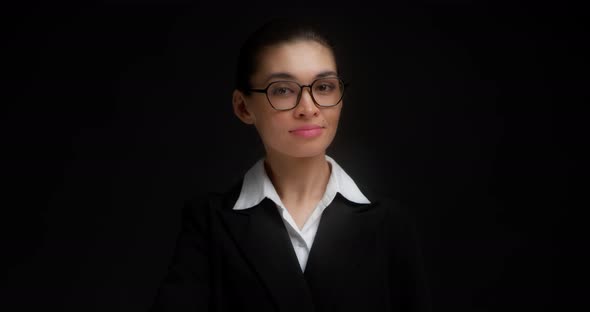 Asian Woman in Business Clothes and Glasses Shows a Hand Gesture Come Here