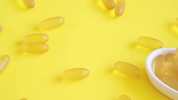 Closeup Omega 3 Fish Oil Capsules in White Plate on Yellow Background
