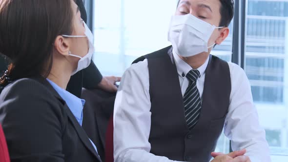 office lifestyle asian businessman and businesswoman wearing protective face mask