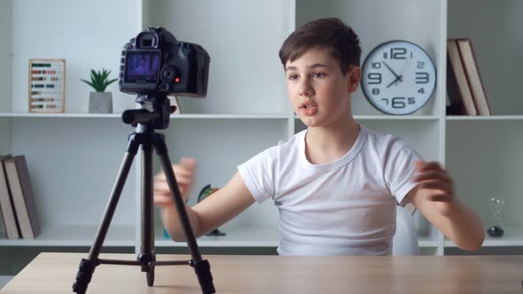 Boy Videoblogger Filming New Vlog Video with Professional Camera at Home