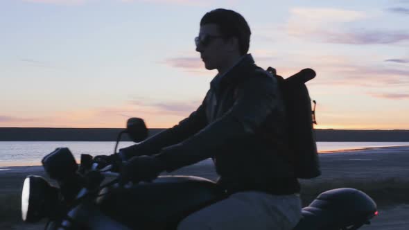 Motorcyclist Driving His Motorbike on the Road After Sunset