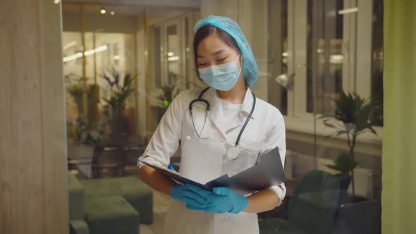 Female Physician Writing Patient's Information