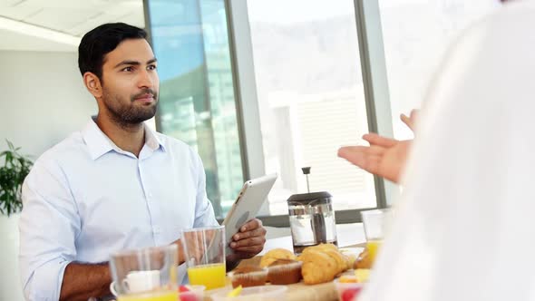 Executive interacting while having breakfast