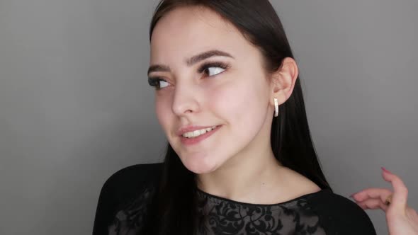 Young Beautiful Healthy Girl Model Posing in the Salon Smiling and Rejoicing in Front of the Camera