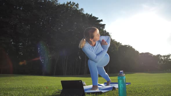 Pretty Woman Training Yoga Pose in Bright Sunlight