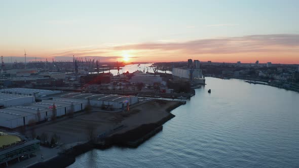 Warehouses and Industrial Buildings on the Banks of Elbe River in Hamburg Germany During Sunset