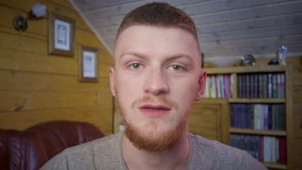 Confident Redhead Man Vlogger Look at Camera Talk Using Computer App Webcam View