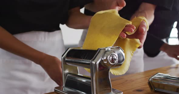 Diverse group of chefs preparing dishes and smiling in a kitchen