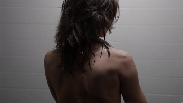 Adult Woman in Shower Washing Her Naked Body Under Water Flows Rear View