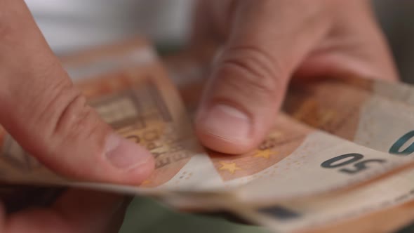 Male Hands Counting 50 Euros Banknotes