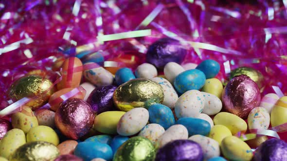 Rotating shot of colorful Easter candies on a bed of easter grass