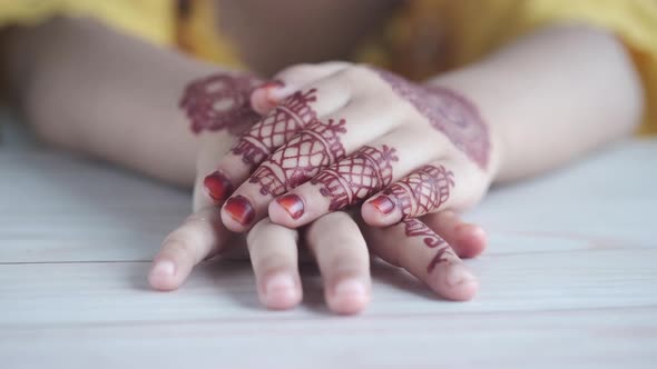 Child Girl Hand with Mehendi on Table