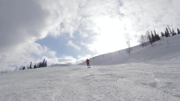 Mountain Skier Skiing On Snowy Piste In Resort On Sunny Day At Winter