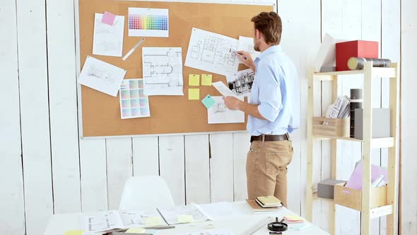 Architector Standing Near Board Looking Through Drawings in Office Slow Motion