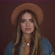 Attractive Young Woman Posing with a Brown Hat Smiling at the Camera on a Brown Background - VideoHive Item for Sale