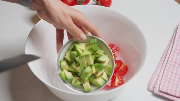 Woman Cuts Vegetables on a Cutting Board for Cooking Homemade Vegetable Salad