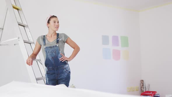 Portrait of a Caucasian woman in quarantine during coronavirus pandemic, doing interior work