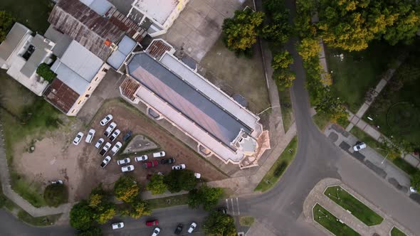 Aerial top down descending over a neogothic church at golden hour