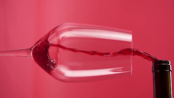 Vertical video, Close-up: red wine is poured into a glass