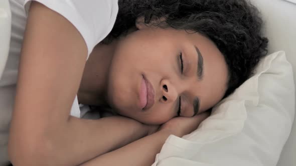 African Woman Sleeping in Bed