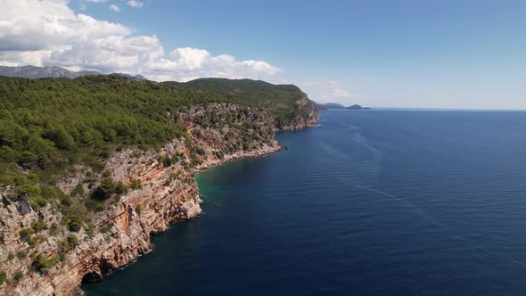 Aerial view of the Pasjaca cliff and beach, blue sea and mountains, Croatia