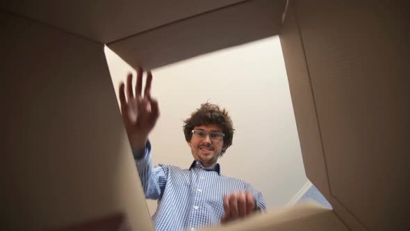 Man Opens Parcel Looks at Delivered Goods Items Feels Happy