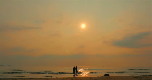 Young Couple Looking Towards the Sun, Against the Sunset, Holding Hands, Go To the Sea, a Romantic