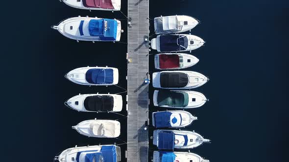 Aerial Flight Above Little Boats Floating In Harbor