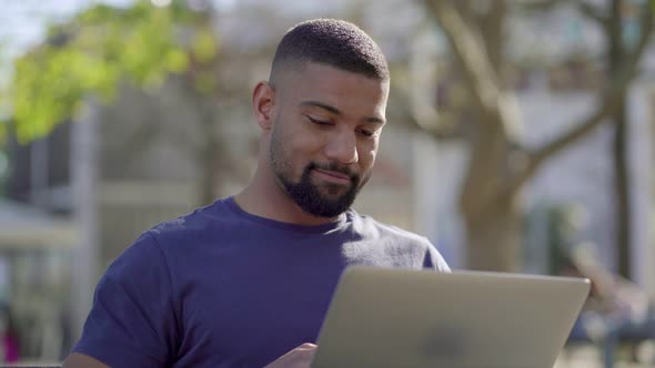 Man Working on Laptop in Park, Thinking, Behaving Emotionally
